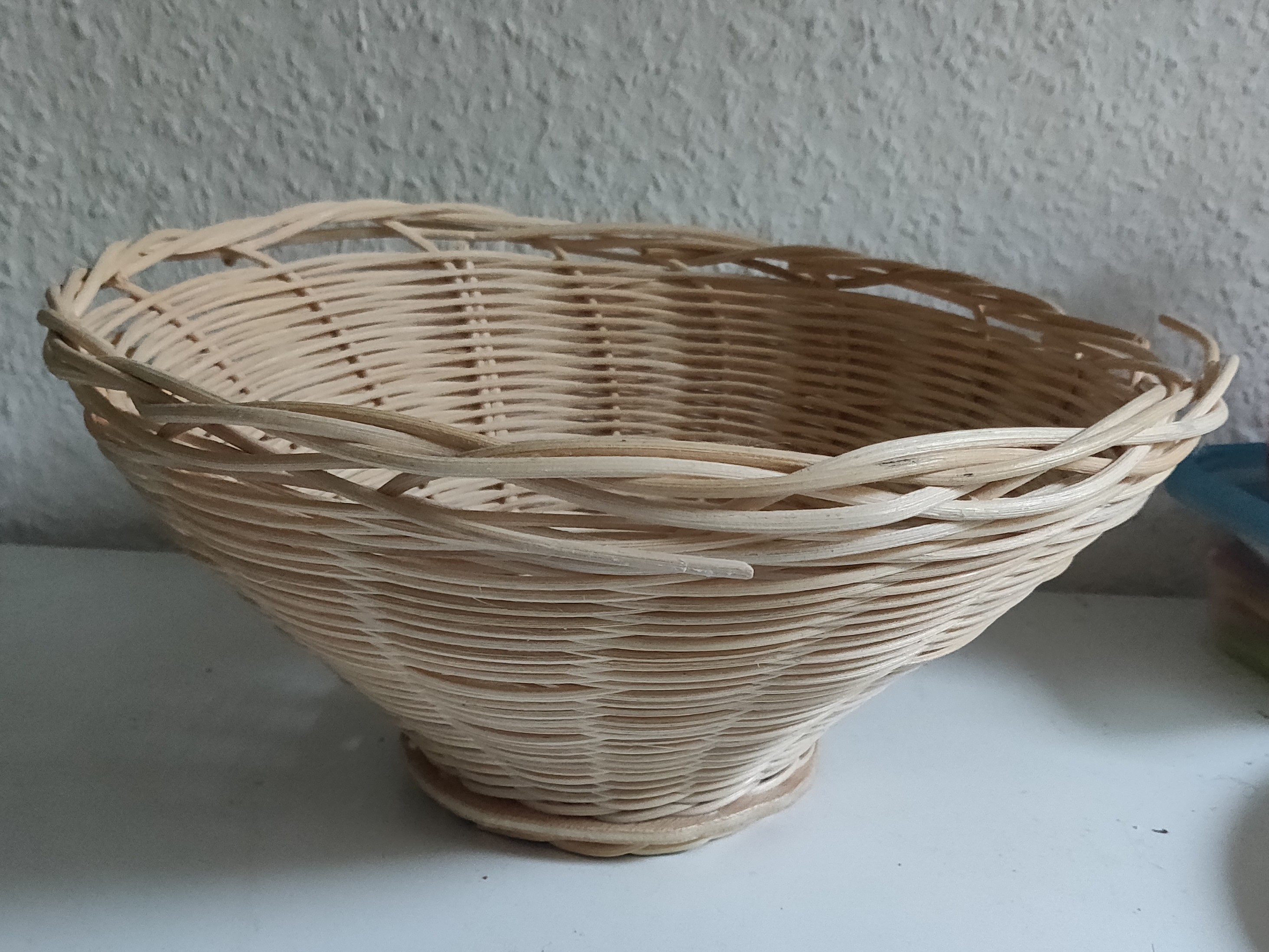 A round basket that is narrow at the bottom.